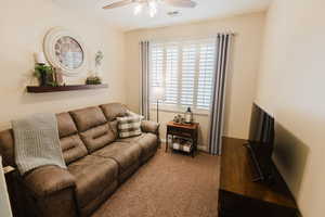 Living room with ceiling fan and carpet floors