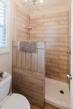 Bathroom featuring toilet and a tile shower