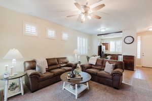 Tiled living room featuring ceiling fan