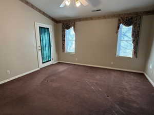 Carpeted spare room featuring ceiling fan and lofted ceiling