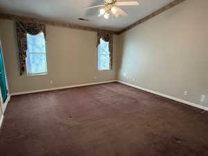 Carpeted spare room with ceiling fan