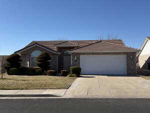 Ranch-style house with a front yard and a garage