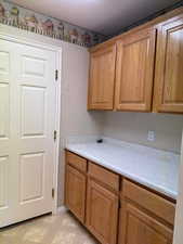 Laundry room with a textured ceiling