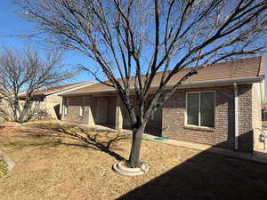 View of home's exterior featuring a patio area and a yard