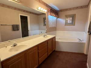 Bathroom with a tub to relax in and vanity