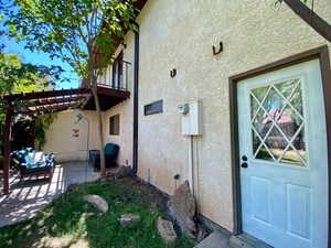 View of side of home with a pergola and a patio area