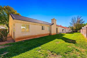 Rear view of property featuring a yard