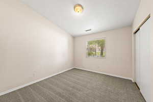 Unfurnished bedroom featuring a closet and carpet