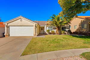 View of front of home featuring a front yard and a garage