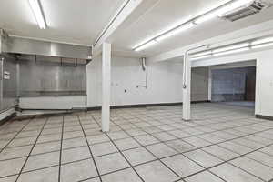 Basement featuring light tile patterned flooring