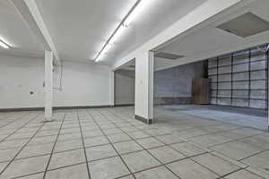 Basement featuring light tile patterned floors