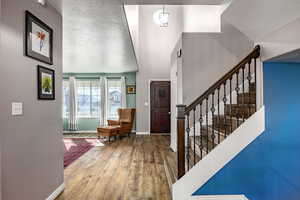 Entrance foyer featuring a textured ceiling and hardwood / wood-style floors