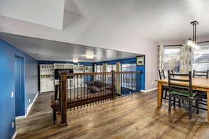 Dining area with a textured ceiling and wood-type flooring