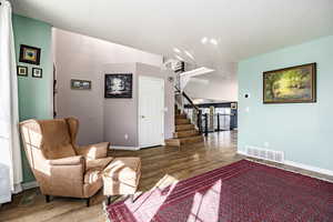 Living area with hardwood / wood-style floors