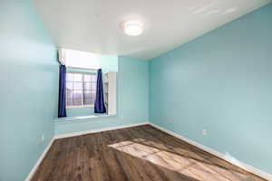 Unfurnished room with hardwood / wood-style floors