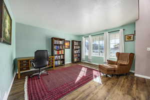 Office space with dark wood-type flooring and a textured ceiling