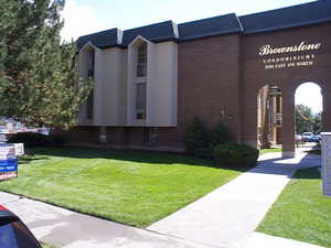 View of side of home with a yard