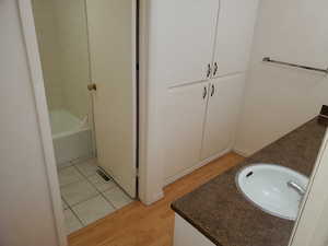 Bathroom featuring hardwood / wood-style flooring and vanity