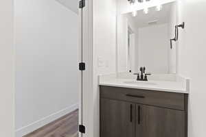 Bathroom with vanity and wood-type flooring