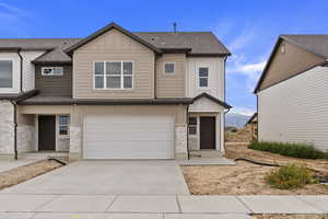 View of front facade featuring a garage