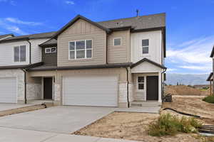 View of front of property featuring a garage and a mountain view