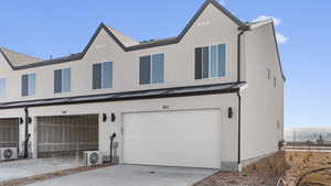 Multi unit property featuring ac unit and a garage