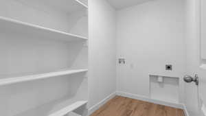 Laundry room featuring hookup for a washing machine, electric dryer hookup, and hardwood / wood-style flooring