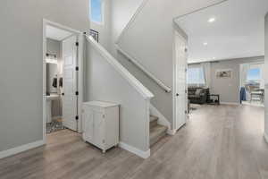 Stairs featuring hardwood / wood-style floors