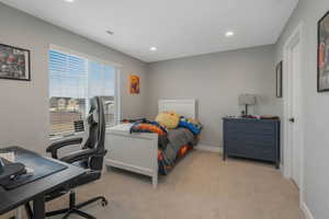 Bedroom with light colored carpet