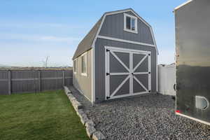 View of outbuilding featuring a yard