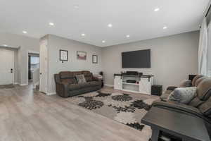 Living room with light hardwood / wood-style flooring