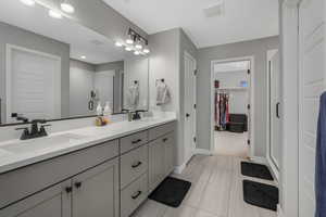 Bathroom featuring a shower with door and vanity