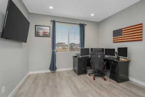 Office with light hardwood / wood-style flooring