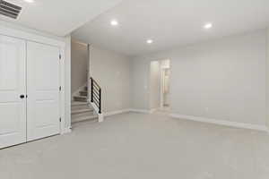 Basement with light colored carpet