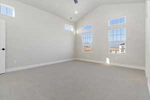 Primary bedroom with vaulted ceiling