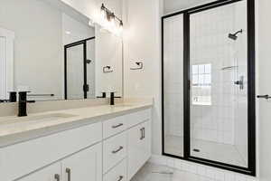 Primary Bathroom featuring vanity and walk in shower with dual shower heads