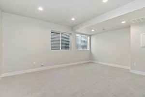 Empty room with light colored carpet