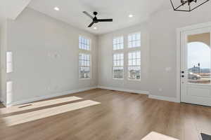 Entrance foyer with ceiling fan and light wood-type flooring