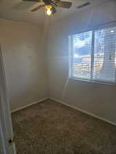 Spare room featuring ceiling fan and carpet flooring