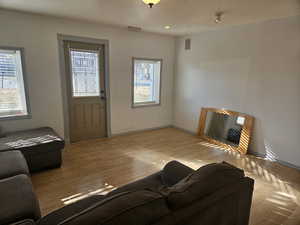 Living room with light hardwood / wood-style floors