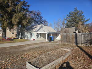 View of side of property with a lawn