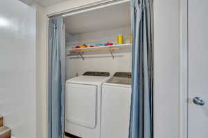 Laundry area featuring washing machine and clothes dryer