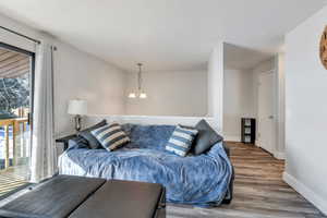 Living room with a chandelier, a wealth of natural light, and hardwood / wood-style floors