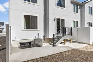 Back of house featuring a patio and cooling unit