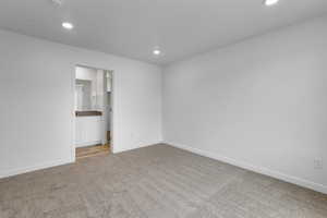 Empty room featuring light colored carpet