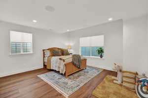 Bedroom with light hardwood / wood-style flooring