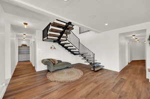 Stairs featuring wood-type flooring and a textured ceiling