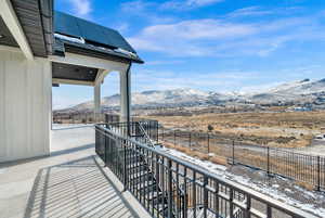 Snow covered back of property featuring a mountain view