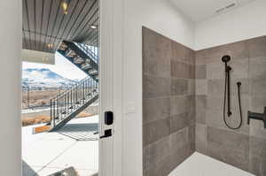 Bathroom with a tile shower and a mountain view