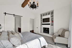 Bedroom featuring dark carpet, a barn door, an inviting chandelier, and lofted ceiling with beams